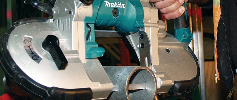 A Man Cutting Metal Pipe With Makita XBP02Z