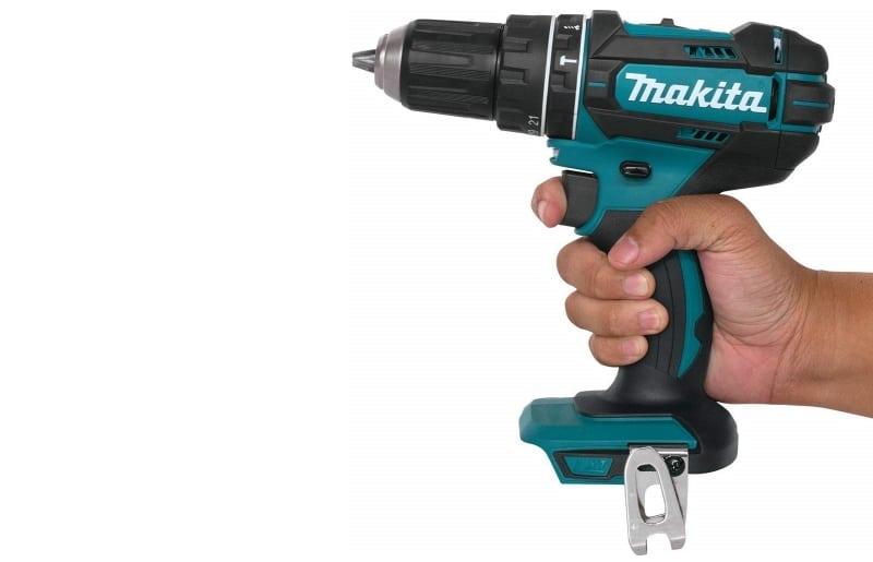 Hand holding a Makita Hammer Driver Drill