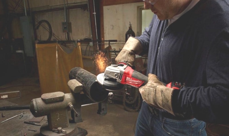 A man working with Milwaukee 2780-20 Cordless Angle Grinder